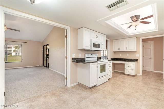 kitchen with ceiling fan, lofted ceiling, white appliances, light carpet, and white cabinets