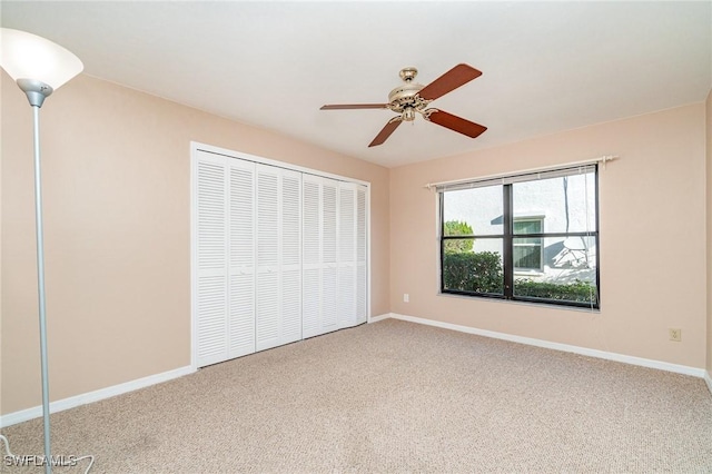 unfurnished bedroom with carpet, ceiling fan, and a closet