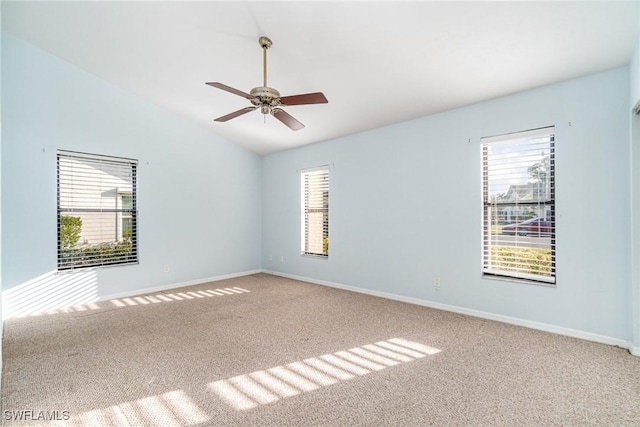 carpeted empty room with ceiling fan and vaulted ceiling