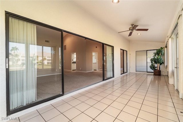 unfurnished sunroom with ceiling fan and lofted ceiling