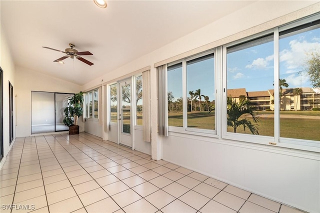 unfurnished sunroom featuring vaulted ceiling and ceiling fan