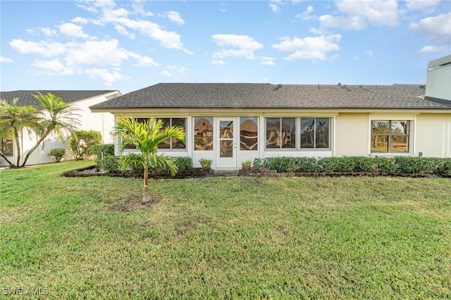 rear view of property with a yard