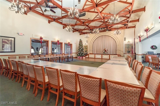 interior space with a high ceiling, ceiling fan, and beam ceiling