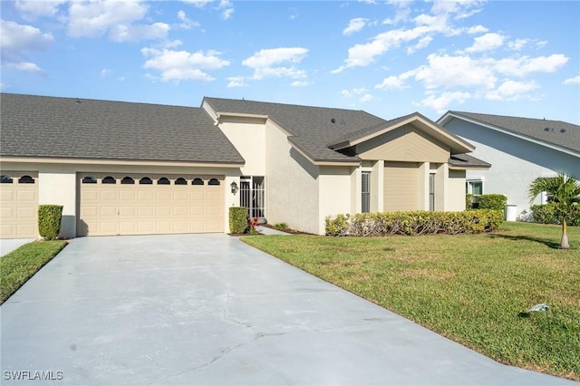 view of front of property with a front lawn and a garage