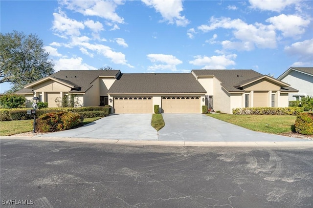 view of front of property featuring a garage and a front yard