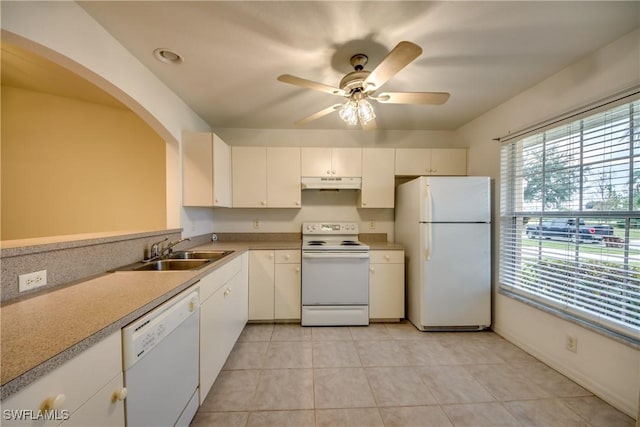 kitchen featuring white appliances, white cabinets, sink, ceiling fan, and light tile patterned floors