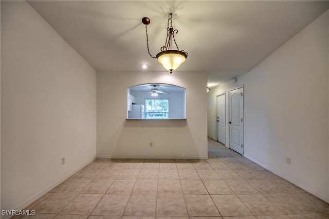 empty room with light tile patterned floors and ceiling fan