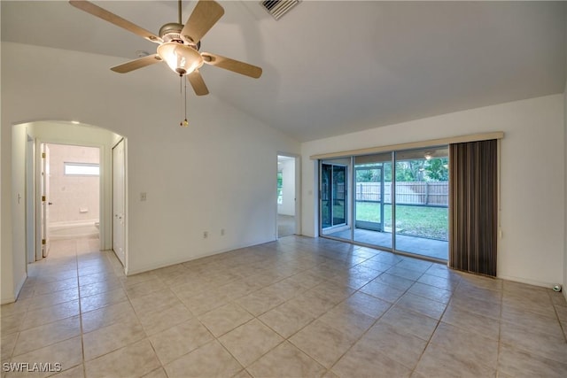 empty room with ceiling fan, light tile patterned floors, lofted ceiling, and a wealth of natural light