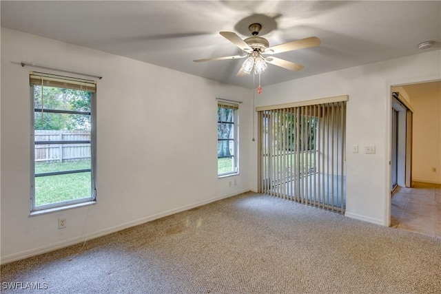 empty room featuring light colored carpet and ceiling fan