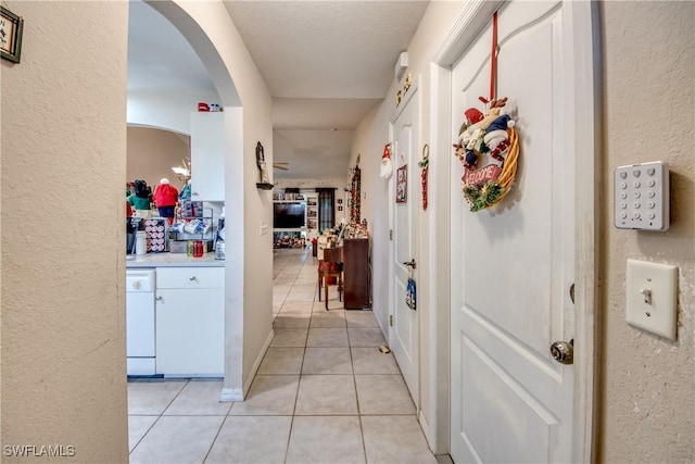 hall featuring light tile patterned floors