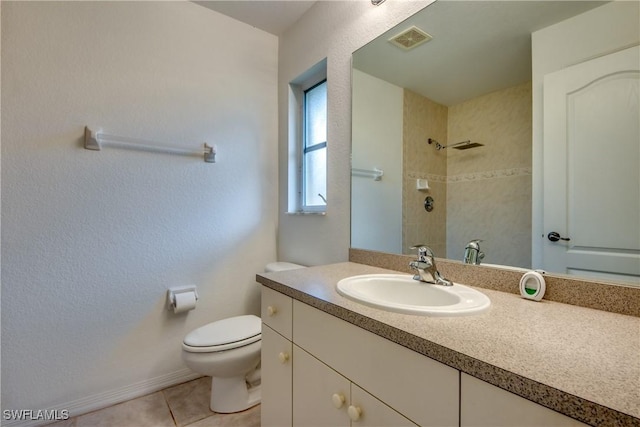 bathroom with tile patterned flooring, vanity, and toilet