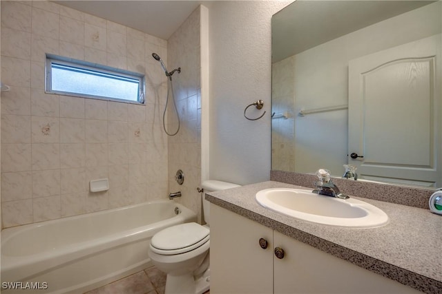 full bathroom with tile patterned floors, tiled shower / bath combo, toilet, and vanity