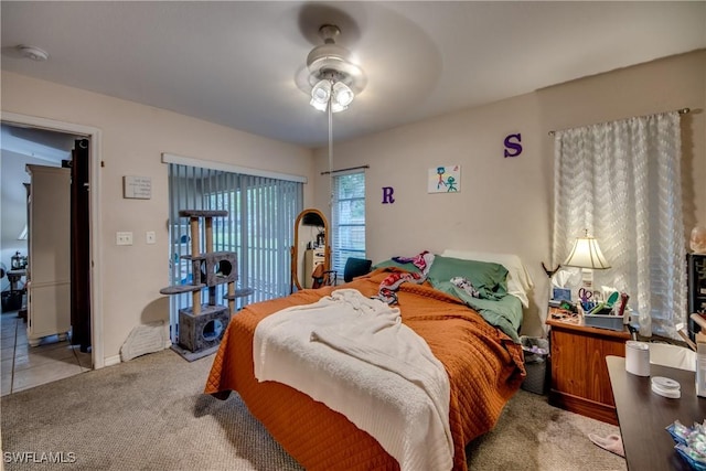 bedroom featuring ceiling fan and light carpet