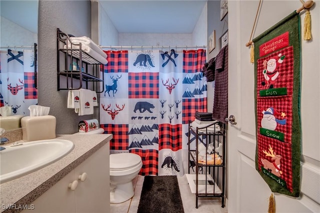 bathroom with tile patterned flooring, vanity, curtained shower, and toilet