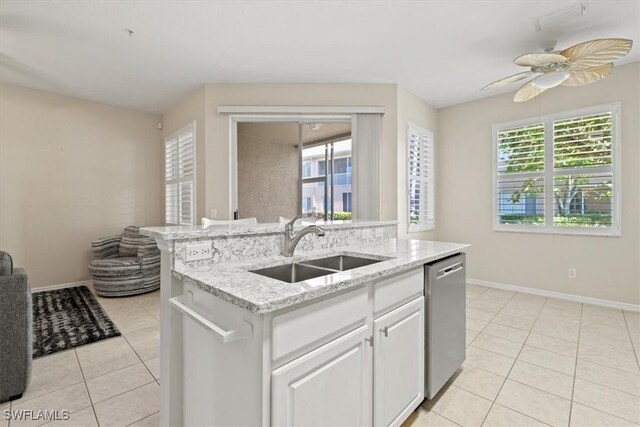 kitchen featuring white cabinetry, dishwasher, sink, a kitchen island with sink, and light tile patterned floors