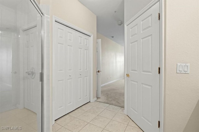 hallway featuring light tile patterned flooring