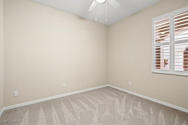 empty room with light colored carpet and ceiling fan