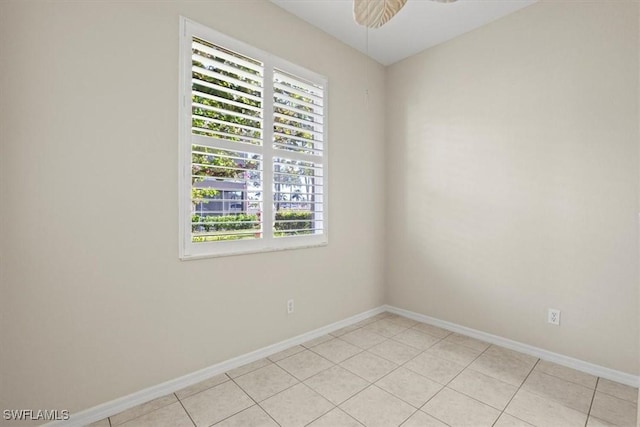 unfurnished room featuring light tile patterned floors and ceiling fan