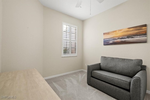 living area featuring ceiling fan and light carpet