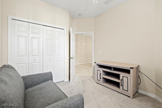 sitting room featuring light colored carpet