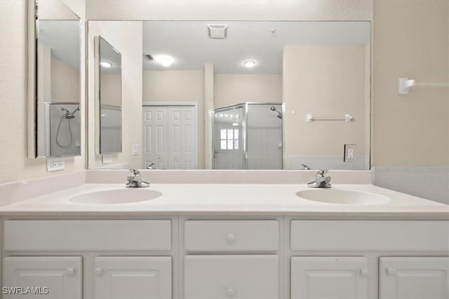 bathroom with walk in shower and vanity