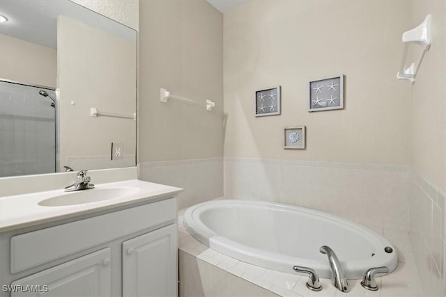 bathroom featuring vanity and plus walk in shower