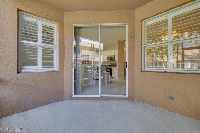 property entrance featuring a patio