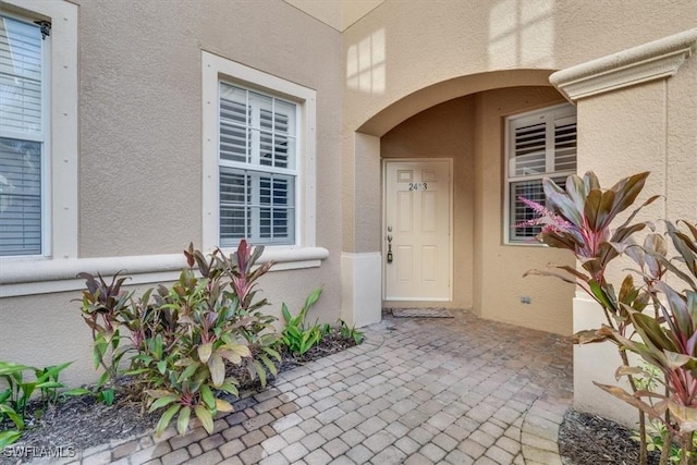 doorway to property with a patio