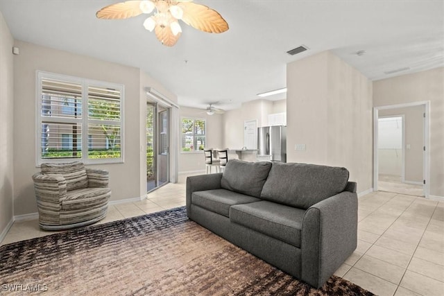 living room with light tile patterned flooring and ceiling fan