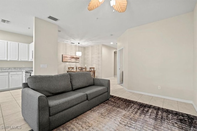 tiled living room featuring ceiling fan