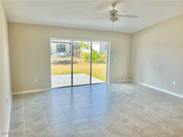 unfurnished room with ceiling fan and light tile patterned floors