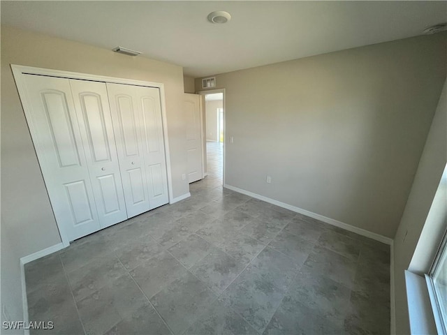 unfurnished bedroom with a closet