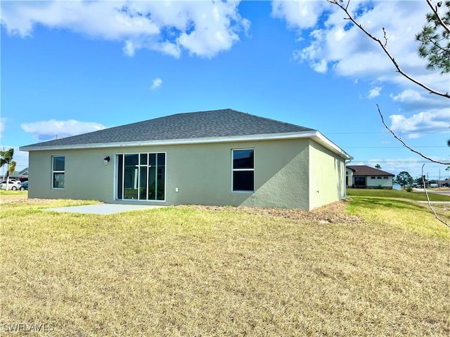 rear view of property with a yard