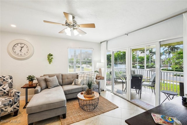 living room featuring ceiling fan and light tile patterned floors