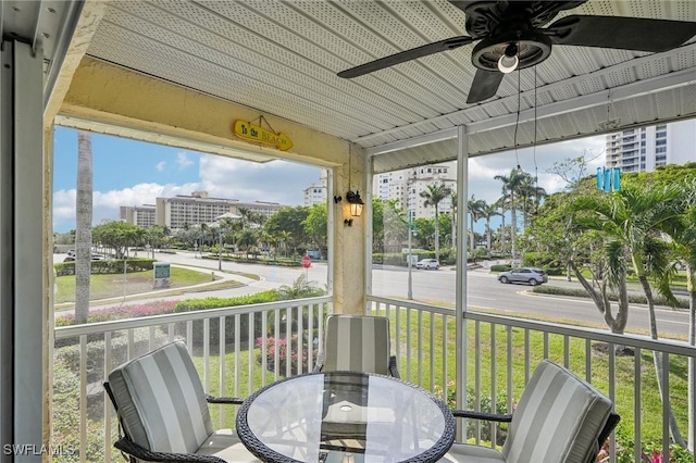 sunroom featuring ceiling fan