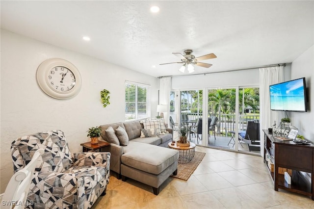 living room featuring light tile patterned floors, plenty of natural light, and ceiling fan