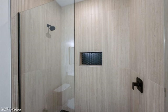 bathroom with tiled shower