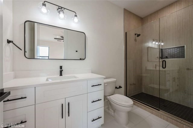 bathroom featuring toilet, vanity, tile patterned floors, and a shower with shower door