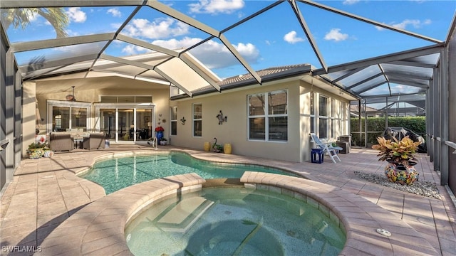 view of swimming pool with an in ground hot tub, a patio, and a lanai