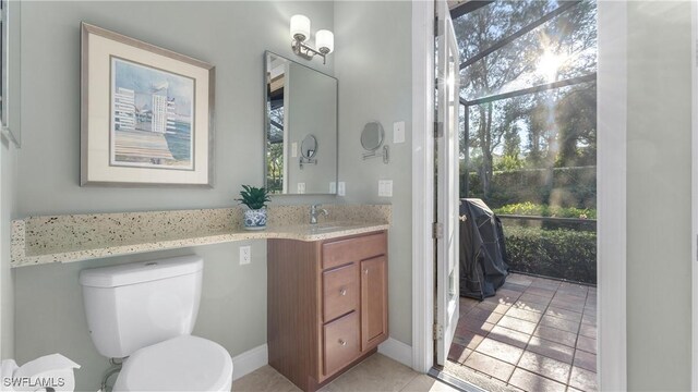 bathroom with tile patterned flooring, vanity, and toilet