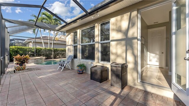 view of patio with glass enclosure