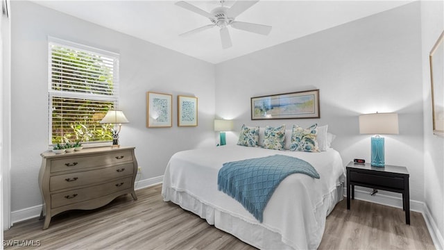 bedroom with ceiling fan and light hardwood / wood-style floors