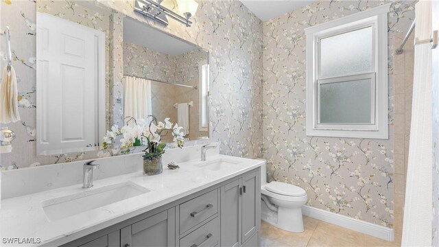 bathroom featuring tile patterned floors, vanity, toilet, and walk in shower