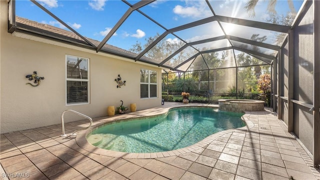 view of pool with an in ground hot tub, glass enclosure, and a patio area