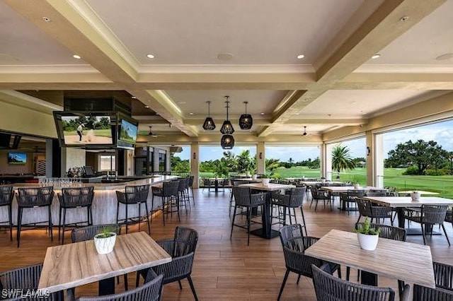 dining space with beam ceiling, plenty of natural light, dark wood-type flooring, and coffered ceiling