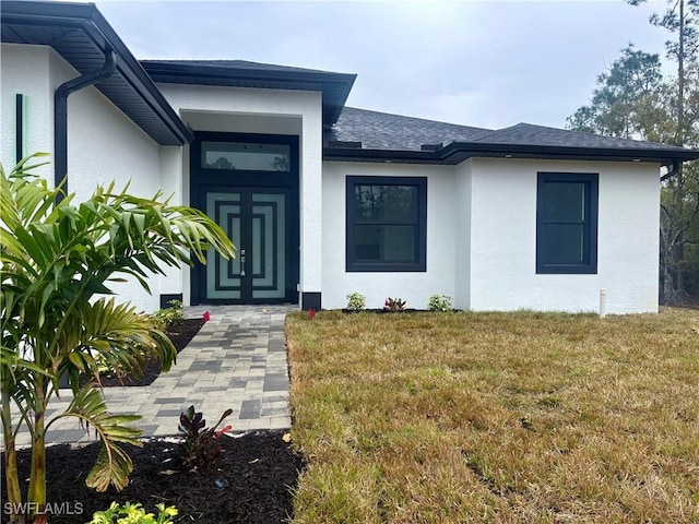 doorway to property with a lawn