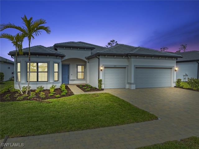 view of front of house with a lawn and a garage