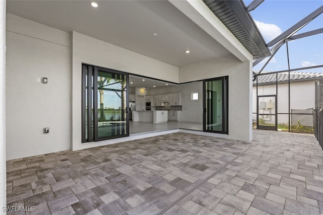 view of patio with glass enclosure