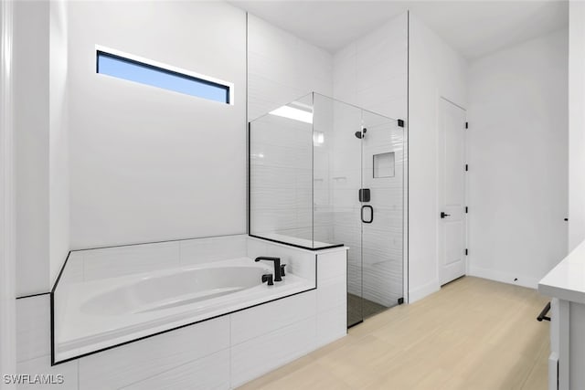 bathroom with separate shower and tub