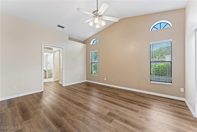 spare room with hardwood / wood-style flooring, ceiling fan, and vaulted ceiling